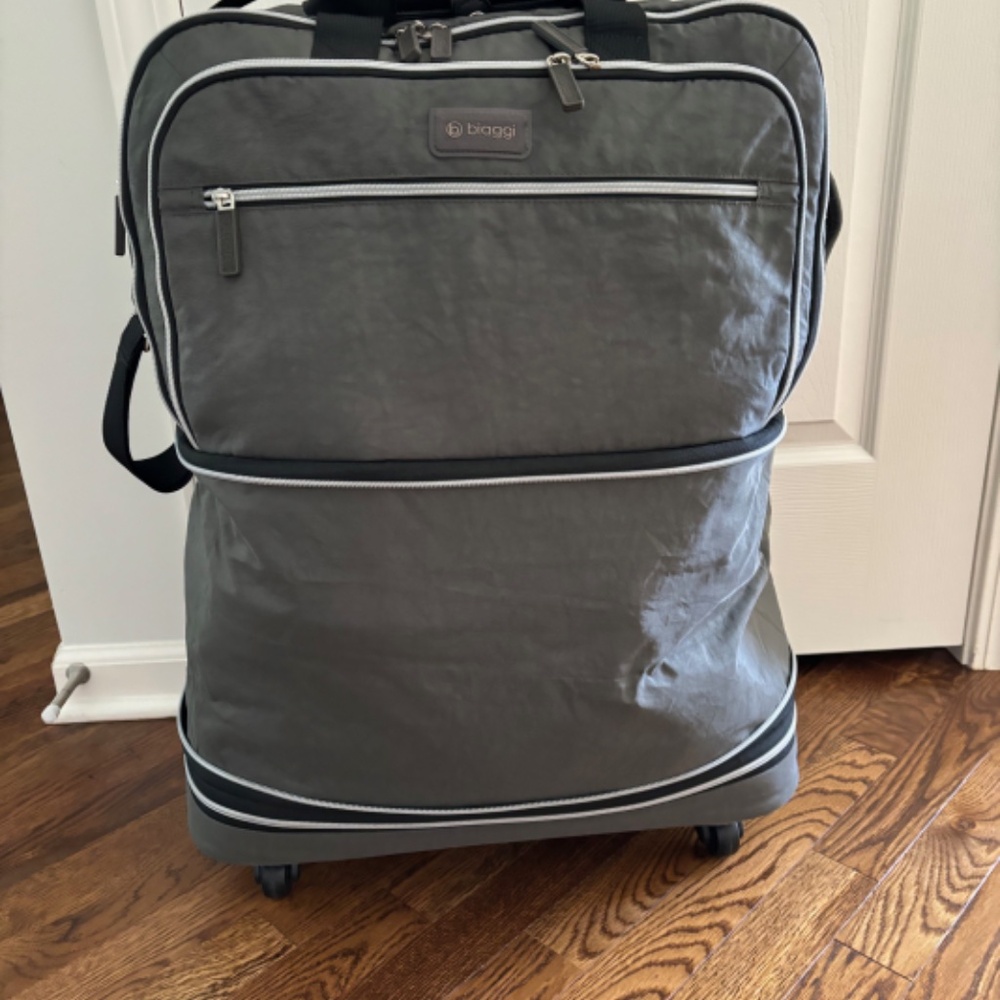 Biaggi brand soft sided wheeled and foldable suitcase with three packing cubes.